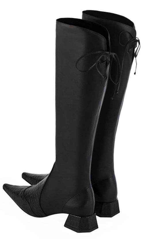 Satin black knee high boots with laces at the back. Pointed toe. Low flare heels. Model Madison Madrid